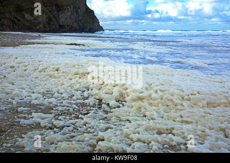 sea foam, ocean foam, beach foam or spume on porthtowan beach cornwall, uk, the foam is usually created during stormy weather. Stock Photo