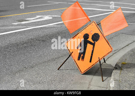 Construction flagger ahead sign on a street Stock Photo