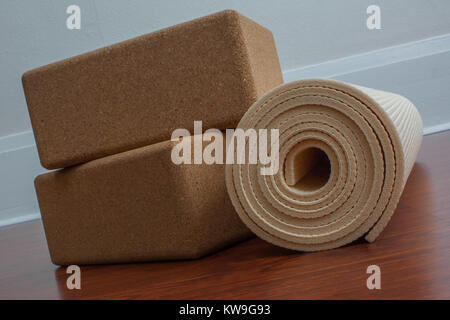 Yoga mat and accessories on wooden floor ready for yoga class Stock Photo