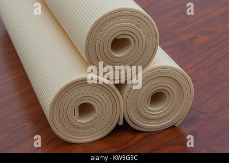 Yoga mat and accessories on wooden floor ready for yoga class Stock Photo