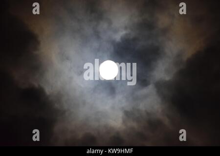 sky with clouds and bright moon by night Stock Photo