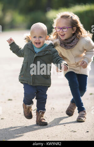Siblings having fun during walk in the park Stock Photo