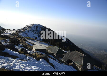 Scenic Triund mountains camps covered by crystal white snow in December 2017 with clear blue sky at Triund Hills,Mcleodganj, Himachal Pradesh, India Stock Photo