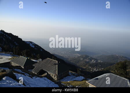 Scenic Triund mountains camps covered by crystal white snow in December 2017 with clear blue sky at Triund Hills,Mcleodganj, Himachal Pradesh, India Stock Photo