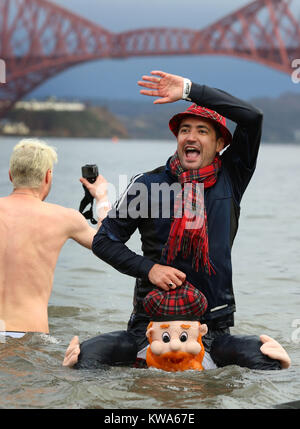 People take part in the Loony Dook New Year's Day dip in the Firth of ...