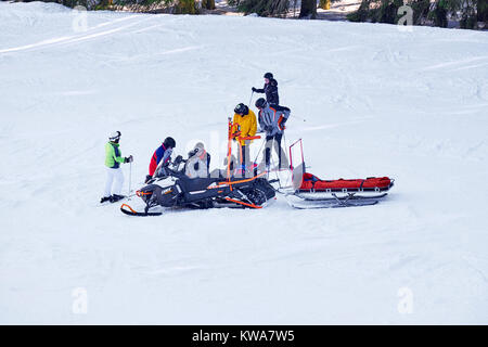 WINTERBERG, GERMANY - FEBRUARY 15, 2017: Rescue snowmobile at an injured skier on a ski slope Stock Photo