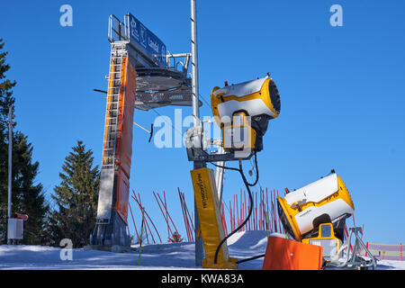 WINTERBERG, GERMANY - FEBRUARY 15, 2017: Ski cannons standing on a top in front of a draw lift  in Ski Carousel Winterberg Stock Photo