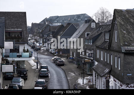 WINTERBERG, GERMANY - FEBRUARY 16, 2017: Narrow street in Winterberg with slate decorated town villas on both sides Stock Photo