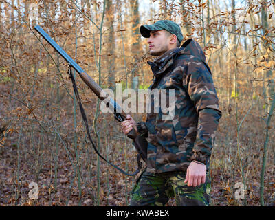 Hunter in camo suit with double barrel shotgun Stock Photo