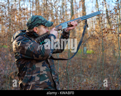 Hunter in camo suit with double barrel shotgun Stock Photo