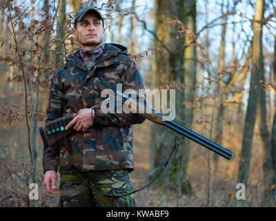 Hunter in camo suit with double barrel shotgun Stock Photo