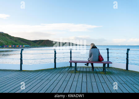 Saltburn-by-the-Sea, United Kingdom, 01st January, 2018. UK Weather.  Woman enjoying the view from Saltburn-by-the-Sea pier in the New Year's Day sunshine.  Credit: Andrew Ellis/Alamy LIve News. Stock Photo