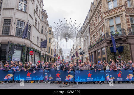 Central London, UK. 1st Jan, 2018. London's spectacular New Year's Day Parade starts at 12 noon in Piccadilly, making it's way down famous West End thoroughfares, finishing in Parliament Square at 3.00pm. Spectators line the route in Piccadilly with Bond Street christmas lights in background. Credit: Malcolm Park/Alamy Live News. Stock Photo