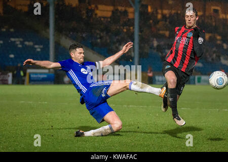 Halifax, UK. 01st Jan, 2018. Scott Garner (FC Halifax Town) clears the ball ahead of Danny Whitehead (Macclesfield Town) reaching it during FC Halifax Town v Macclesfield in the Vanarama National League game on Monday 1 January 2018 at The MBI Shay Stadium, Halifax, West Yorkshire. Photo by Mark P Doherty. Credit: Caught Light Photography Limited/Alamy Live News Stock Photo
