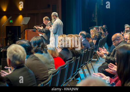 Hempstead, New York, USA. 1st Jan, 2018. Hempstead, New York, USA. January 1, 2018. L-R at far right of stage, HAFIZ ABAIDULLAH RANA the Imam of Hamza Masjid gives recitation of Holy Qur'ann, and MALIK NADEEM ABID translates and says prayers, during Swearing-In ceremony of Laura Gillen as Hempstead Town Supervisor, and Sylvia Cabana as Hempstead Town Clerk. Seen from off-stage side right. Credit: Ann Parry/ZUMA Wire/Alamy Live News Stock Photo