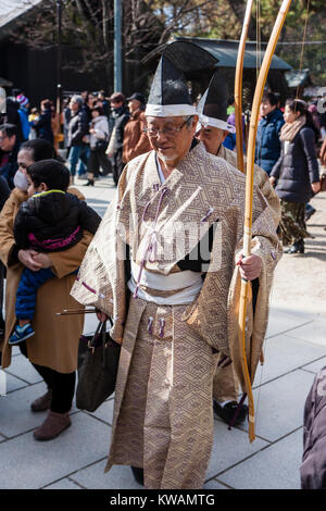 Japan, Nishinomiya Shinto Shrine, New year. Elderly Male archer dressed in Heian period style, walking through the shrine grounds after a new year archery contest, common for New Year and other festive days in Japanese shrines. Stock Photo