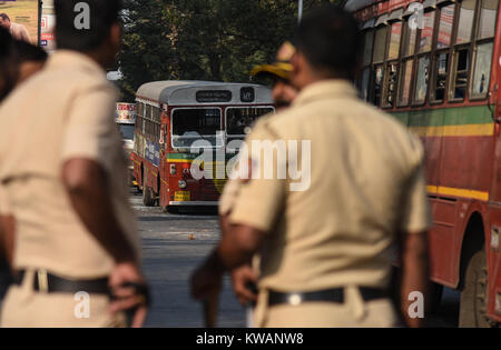 Mumbai. 2nd Jan, 2018. Indian policemen patrol the area as a public transport bus was damaged by the Dalit Protesters in Mumbai, India, Jan. 2, 2018. Protests erupted in several parts of Mumbai on Tuesday, a day after a 28-year-old Dalit died in Pune district following an altercation between two groups during celebrations to mark the bicentenary of a British-Peshwa war. Credit: Xinhua/Alamy Live News Stock Photo