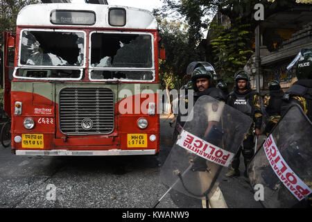 Mumbai. 2nd Jan, 2018. Indian policemen patrol the area as a public transport bus was damaged by the Dalit Protesters in Mumbai, India, Jan. 2, 2018. Protests erupted in several parts of Mumbai on Tuesday, a day after a 28-year-old Dalit died in Pune district following an altercation between two groups during celebrations to mark the bicentenary of a British-Peshwa war. Credit: Xinhua/Alamy Live News Stock Photo