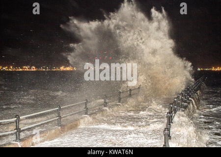 New Brighton, Cheshire. 3rd January 2018. UK Weather. Storm Eleanor hits with 97mph ‘hurricane force' winds and flooding as forecasters warn of ‘danger to life' from flying debris. Hitting the sea wall defences at high tide, huge waves crashed over the promenade walkway at New Brighton on the Wallasey peninsula in Cheshire. An amber warning in place overnight and into Wednesday morning says there is a good chance of damage to buildings. Credit: Cernan Elias/Alamy Live News Stock Photo