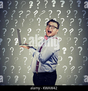 Chubby shocked man holding laptop and looking frustrated at camera having problems and questions. Stock Photo
