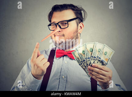 Obese formal man with long nose having money after conducting fraud. Stock Photo