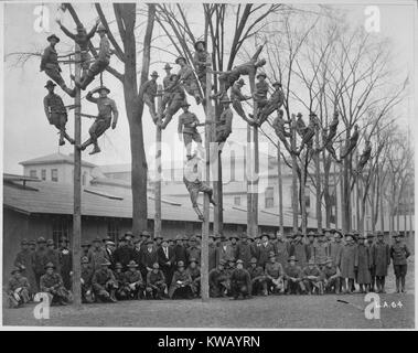 Students and instructors of a Pole-Climbing course for telephone electricians during Student Army Training Corps (SATC) vocational training at the University of Michigan, Ann Arbor, Michigan, 1918. Image courtesy National Archives. Stock Photo