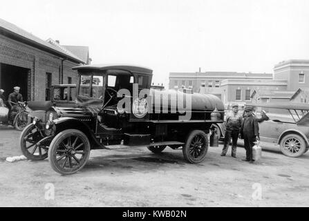 Truck making delivery of gasoline to US Naval training station, two men holding a container standing beside, Newport, Rhode Island, USA, 1920. () Stock Photo