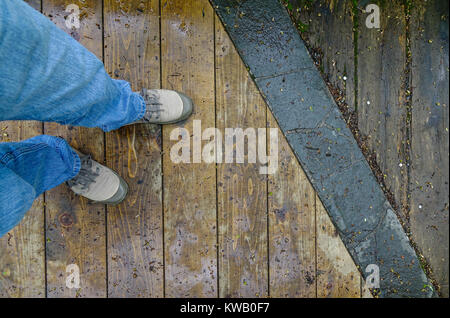 Sneaker shoes on wooden floor of hiking trail at Oirase Gorge in Aomori, Japan. Stock Photo