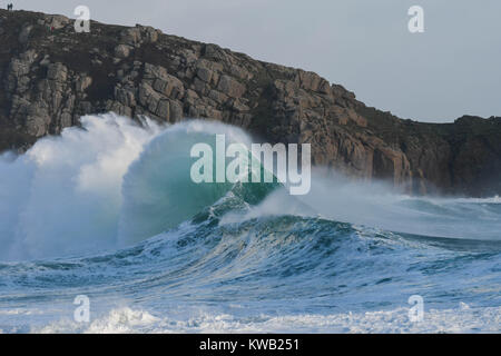 Stormy waves of winter down at the beach in Porthcurno, Cornwall just as Storm Elenor was picking up speed and force.  Shows the force of nature. Stock Photo