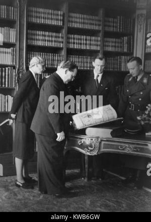 Hermann Goering at 'Einsatzstab Rosenberg' headquarters in Paris, France. Alfred Rosenberg is in uniform next to art historian and dealer Bruno Lohse (second from right). The Nazi German officials were involved in the plundering of great European art works for a future 'Fuhrer Museum', as well as for their personal collections. March 10, 1942. World War 2. (BSLOC 2014 8 154) Stock Photo