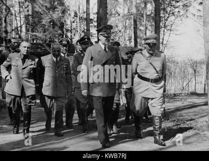 Adolf Hitler and Hermann Goering walking in a group. L-R: Martin Bormann, Robert Ley and Heinrich Himmler. They were at Hitler's headquarters on his birthday. April 20, 1942, during World War 2. (BSLOC 2014 8 172) Stock Photo
