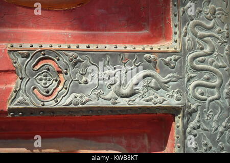 Chinese dragon detail on red gate of Forbidden City palace - Beijing, China Stock Photo