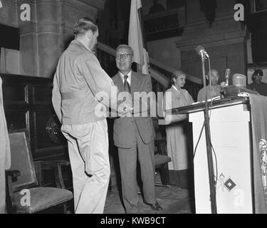 South Korean President Syngman Rhee accepting the return of the battered capital of Seoul from Gen. Douglas MacArthur. Sept 29, 1950. In the background is Mrs. Syngman Rhee. Korean War, 1950-53. (BSLOC 2014 11 58) Stock Photo