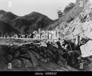 U.S. 3rd Army Division patrol pinned down by Chinese fire from the hills as they protect a convoy under attack in north-east Korea 1950. Korean War, 1950-53. (BSLOC 2014 11 95)