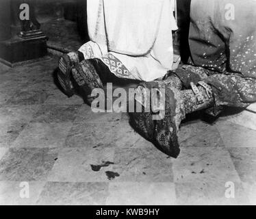With soiled army boots, a Chaplain and soldier kneel at Catholic Mass is held for two dead soldiers. Oct. 11, 1944. San Benedetto, Italy. World war 2. (BSLOC 2014 10 51) Stock Photo