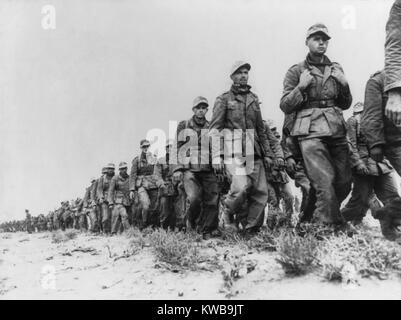 German Panzer prisoners captured during the Battle of Libya. Taken in the early phase of the battle, they are marching from the battle front to a prisoners-of-war camp near Tobruk. Ca. 1942 during World War 2. (BSLOC 2014 10 6) Stock Photo