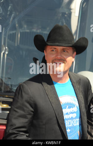 NEW YORK, NY - SEPTEMBER 26: Big & Rich's Big Kenny and John Rich pose in fron of their Greyline 'Ride of Fame' tour bus at Pier 78 on September 26, 2014 in New York City.  People:  John Rich Stock Photo