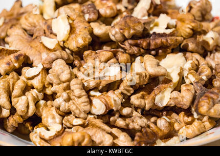 Kernels of walnuts on the plate. Walnut background Stock Photo