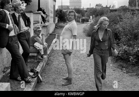 Drunk man on a works office party with colleagues making a fool of himself 1970s London, they are on have been on a river boat cruise on the Thames, near Hampton Court Richmond. Uk 70s Britain HOMER SYKES Stock Photo