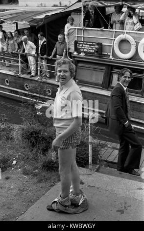 Drunk man on a works office party with colleagues making a fool of himself 1970s London, they are on have been on a river boat cruise on the Thames, near Hampton Court Richmond. Uk 70s Britain HOMER SYKES Stock Photo