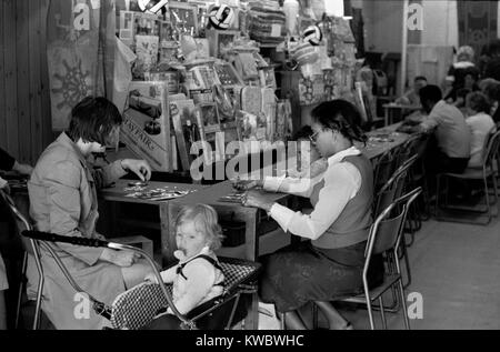 1970s UK London mother and child playing Bingo in an amusement arcade. Multicultural Britain 70s England Portobello Road, London. 1975 UK HOMER SYKES Stock Photo