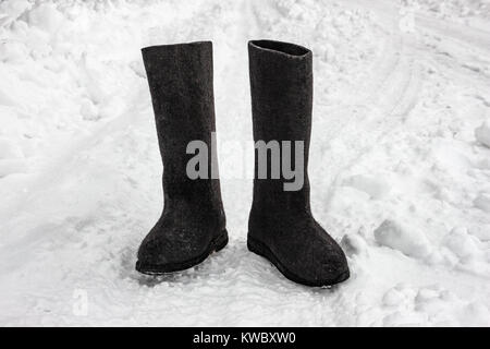 Felt boots on the snow. Russian footwear - valenki Stock Photo