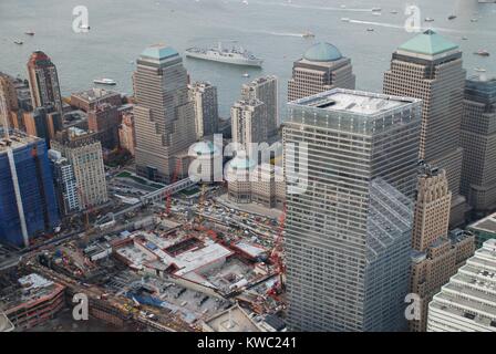 World Trade Center Ground Zero site under reconstruction, Nov. 2, 2009. In right foreground is the new WTC 7. In the Hudson River is the USS NEW YORK, built with 7.5 tons of steel from the World Trade Center in her bow. U.S. Navy Photo by Specialist Eric M. Durie (BSLOC 2015 2 128) Stock Photo