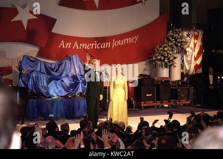 First Lady Hillary Clinton wearing an Oscar de la Renta evening gown at a 1997 Inaugural Ball. President Bill Clinton waves to the crowd beyond the press photographers. Jan. 20, 1997. (BSLOC 2015 2 198) Stock Photo