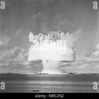 The BAKER test of Operation Crossroads, July 25, 1946. 2 seconds after the underwater detonation, the 'birthday cake on a platter' stage of the explosion cloud formed. 2 million tons of water rises, towering about the target ships. At the cloud base a wall of spray, mist and air sweeps outward as millions of tons of water fell back into the lagoon. (BSLOC 2015 2 7) Stock Photo