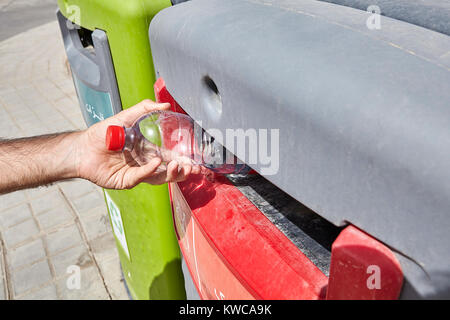 Trash Segregation, Man putting empty plastic bottle in recycling bin, Yazd, Iran. Stock Photo