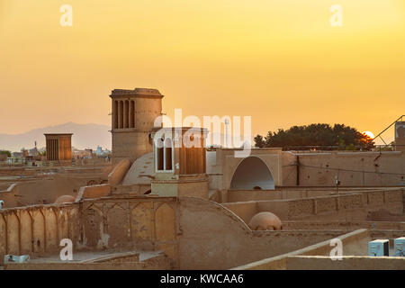 View from a rooftop of Yazd old town in Iran on sunset, with wind towers for air ventilation in a house. Stock Photo