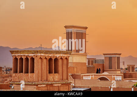 View of the center city Yazd in Iran at sunset, the Persian tower windcatchers are used for passive ventilation of living spaces. Stock Photo