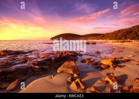 Sunset Cala Violina bay beach in Maremma, Tuscany. Travel destination in Mediterranean sea. Italy, Europe. Stock Photo