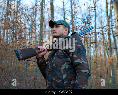 Hunter in camo suit with double barrel shotgun Stock Photo